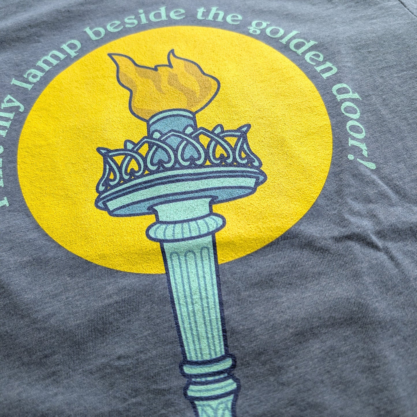 I lift my lamp beside the golden door! Bella Canvas Unisex T-Shirt - Circle Design
